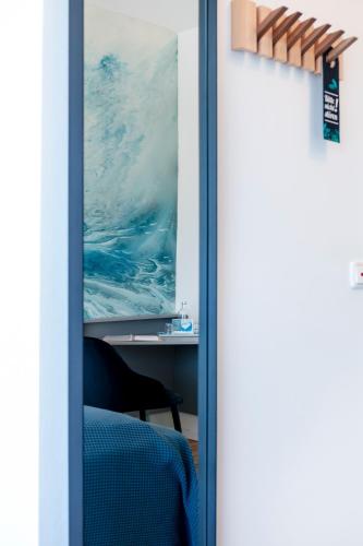 a sliding glass door with a view of the ocean at Hotel Bethanien in Langeoog