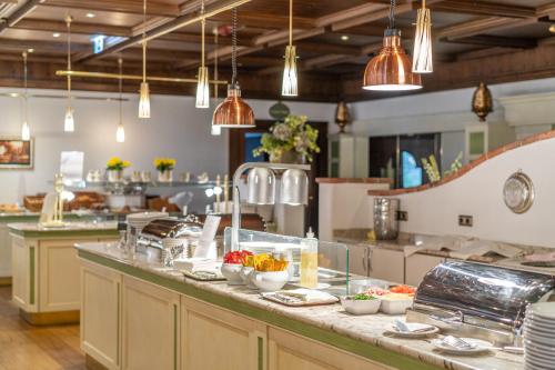 a kitchen with a counter with bowls of food on it at EUROPÄISCHER HOF Bad Gastein in Bad Gastein