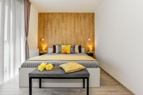 a bedroom with a bed with yellow flowers on a table at KORZO LIPNO C in Lipno nad Vltavou