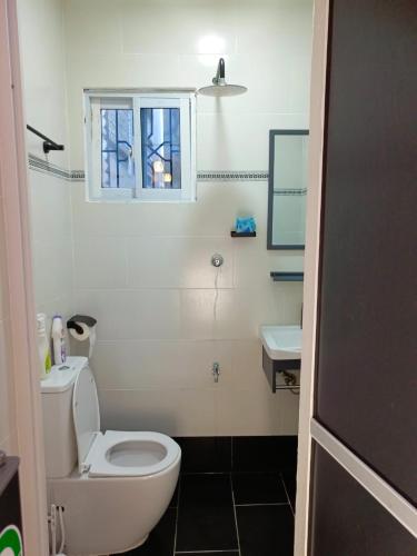 a bathroom with a white toilet and a sink at SPACIOUS 2 AND 3 BEDROOM APARTMENTs in Mtwapa