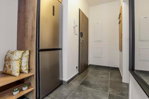 a hallway with a refrigerator and a door at KORZO LIPNO C in Lipno nad Vltavou