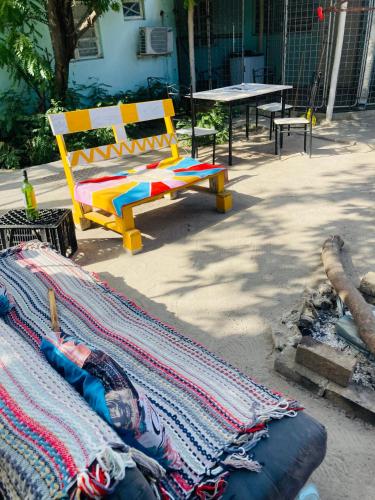 a colorful bench sitting next to a table with a blanket at Home Choice in Maun