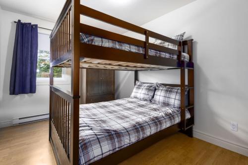 a bedroom with bunk beds in a house at Lake and Pool Table - Au Pied du Lac in Labelle