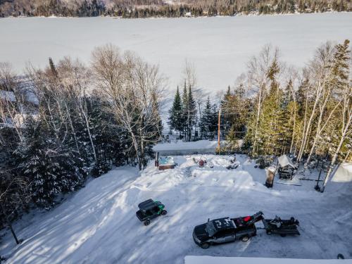 an aerial view of a house in the snow at Lake and Pool Table - Au Pied du Lac in Labelle