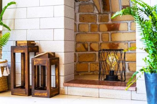 two wooden lanterns sitting next to a brick wall at Tiên Hoa Sơn Villa in Da Lat