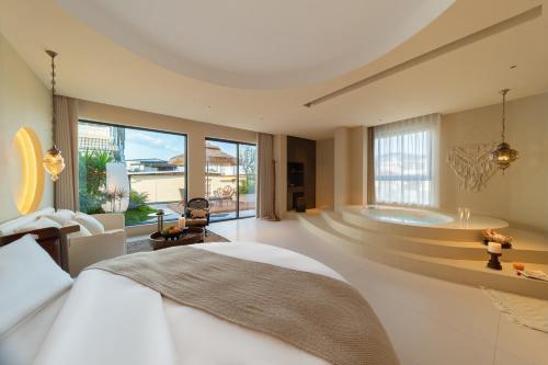 a bedroom with a large bed and a bath tub at Warm Shore in Taiping