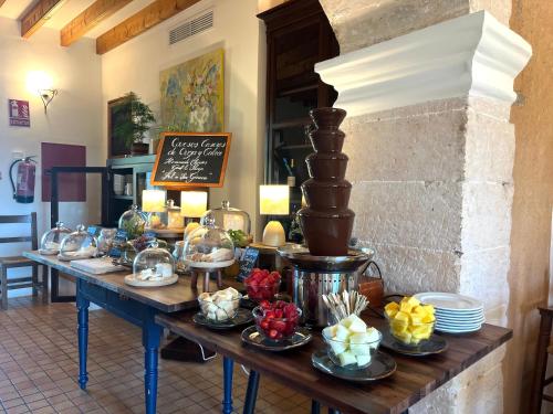 a table with a buffet of food on it at Finca Hotel Ses Cases Noves in Sant Llorenç des Cardassar