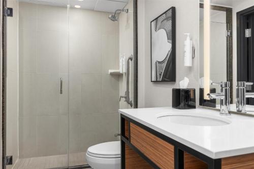 a bathroom with a sink and a toilet and a shower at Hilton Garden Inn Toronto Airport in Mississauga