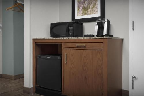 a room with a tv on a counter with a trash at Hilton Garden Inn Oklahoma City/Bricktown in Oklahoma City