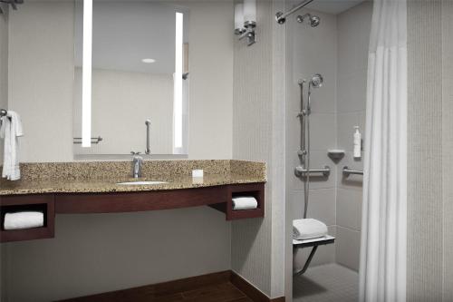 a bathroom with a sink and a shower at Hilton Garden Inn Oklahoma City/Bricktown in Oklahoma City