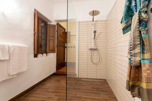 a bathroom with a shower with a glass door at Can Pep Den Sitges in Sant Joan de Labritja