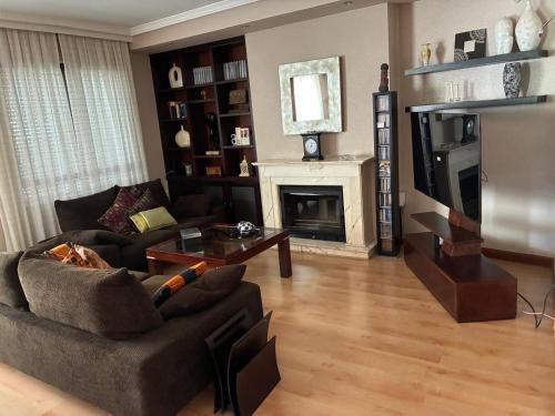 a living room with a couch and a fireplace at Casa de los boticarios, casa rural in El Arenal