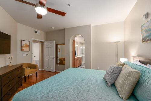 a bedroom with a blue bed with a ceiling fan at Mountain View #912 Surprise in Surprise
