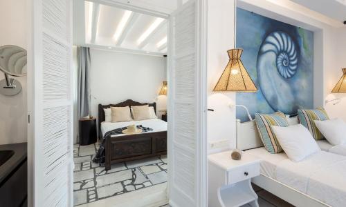 a white room with a bed and a couch at Villa Romantica Naxos in Maragkas