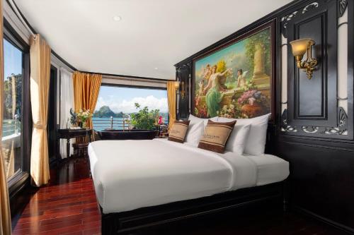 a bedroom with a large white bed with a painting on the wall at Athena Royal Cruise - Luxury in Halong Bay in Ha Long