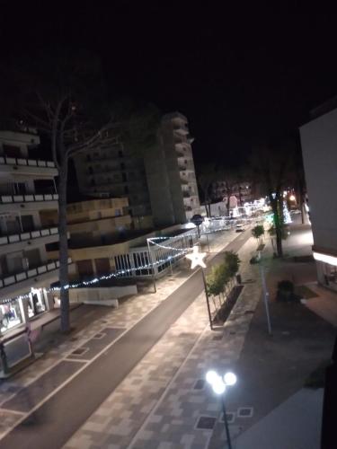 a city street at night with street lights at Casa Martini in Lido degli Estensi