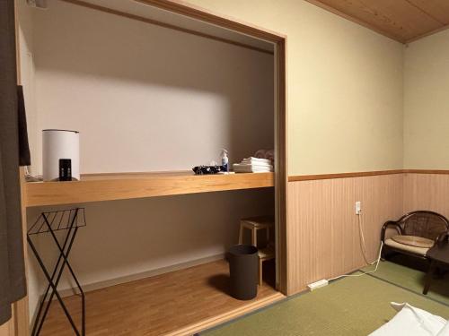 a large mirror in a room with a desk at GuestHouse Guu in Fujikawaguchiko