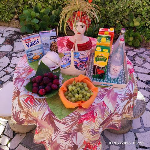a picnic table with food and fruit on it at Casapatrizia B&B Sirmione in Sirmione