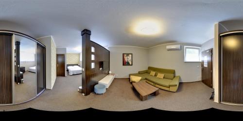 a hotel room with a couch and a mirror at Penzion Set in Košice