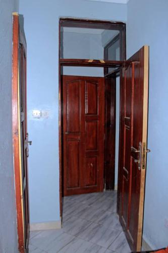an open door to a room with an open hallway at Tenzi BnB in Jinja