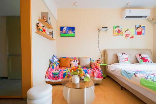 a room with a bed and a couch and a table at Suyi Hotel Apartment in Sha-ho-p'u