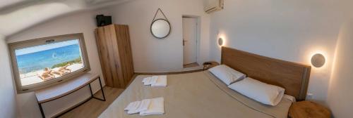 a bedroom with a bed and a large screen television at Casa del mare in Pýrgos