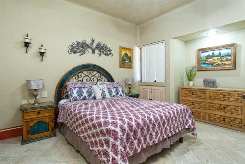 a bedroom with a large bed and a dresser at Marina Pinacate in Puerto Peñasco