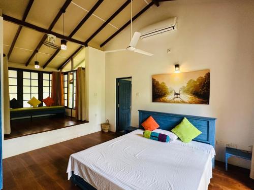a bedroom with a large bed in a room at Gaia Lake Bungalow Kandalama in Dambulla
