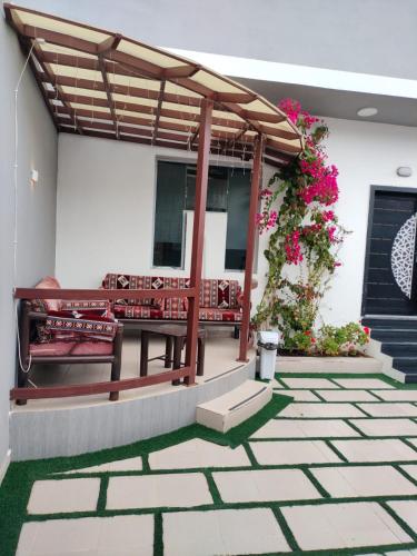 a patio with benches and flowers on a house at فلل الكناري in Taif