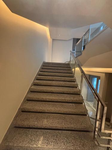 a stair case in a building with a stair railing at The Supreme Hotel and Banquet in Gaya