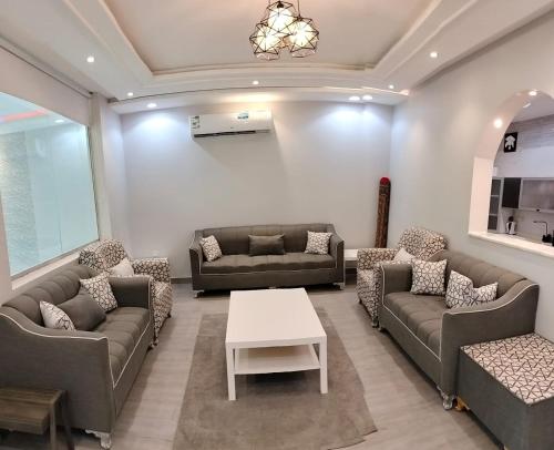 a large living room with couches and a table at فلل الكناري in Taif