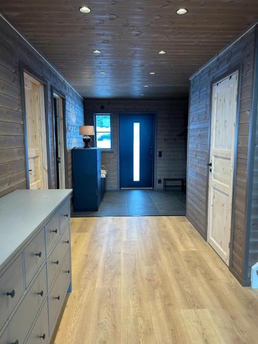 a large room with a wooden floor and a door at Borgahyllan 2 in Borgafjäll