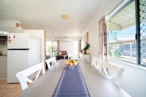 a kitchen with a table with a bowl of fruit on it at Townsville Family Getaway in Townsville