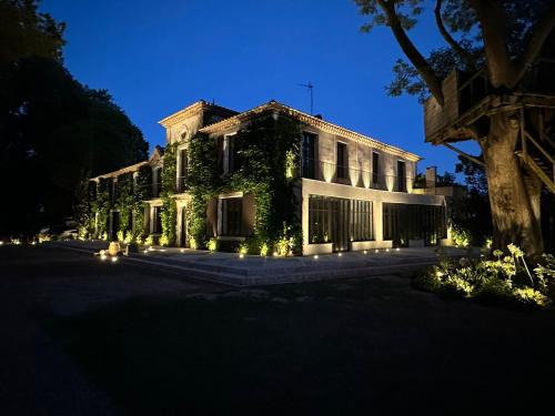 a building with lights in front of it at night at La Jasso Hôtel, Maison de Famille in Carcassonne