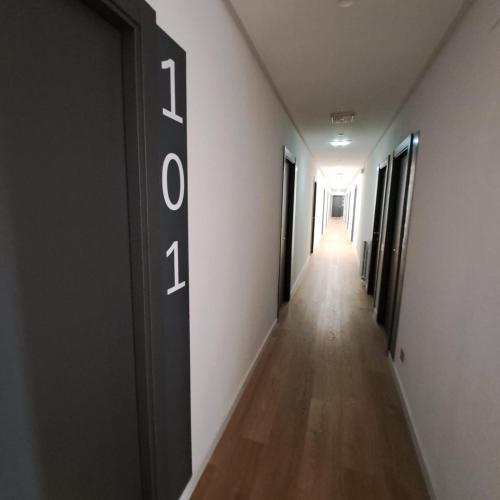 a hallway with a long corridor with the number on the door at Miresileón in León