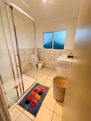 a bathroom with a shower and a toilet at The Crossing Retreat in Turangi