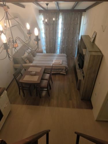 a small living room with a table and a bed at студио КОМФОРТ в центъра на град Сандански in Sandanski