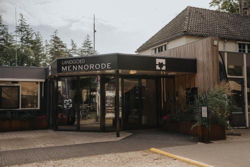 an entrance to a store with a sign that readsmanaged manpowerride at Landgoed Mennorode in Elspeet