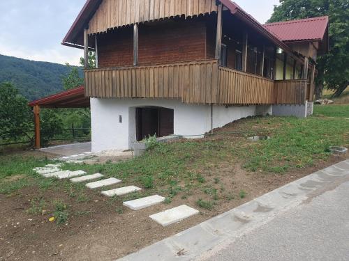 a house with a building with a porch at Jadrica in Žumberak