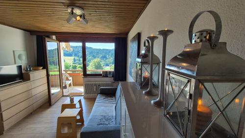 a living room with a kitchen with a large window at Haus Norea, Top 65 in Sankt Urban