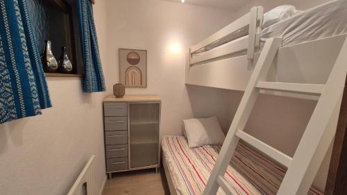 a small bedroom with a bunk bed and a ladder at Haus Norea, Top 65 in Sankt Urban