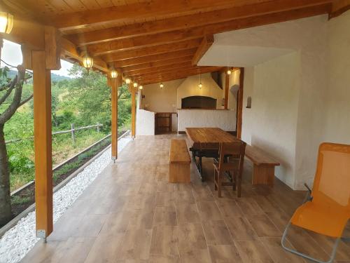 a dining room with a wooden table and benches at Jadrica in Žumberak