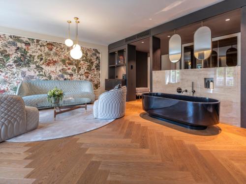 a bathroom with a tub in the middle of a room at Steigenberger Icon Europäischer Hof Baden Baden in Baden-Baden