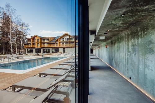 a view of the swimming pool from the window of a building at Mövenpick Resort & Spa Karpacz in Karpacz