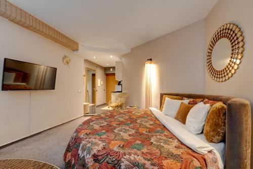 a bedroom with a large bed and a flat screen tv at SPA apartments in city centre in Vilnius