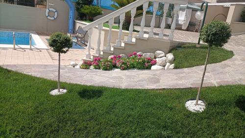 two trees in the grass in front of a house at Comfort &Relax B&B&Spa in Villa Rosa