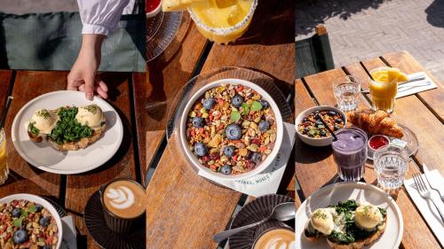 a wooden table with plates of food on it at The July - Boat & Co in Amsterdam