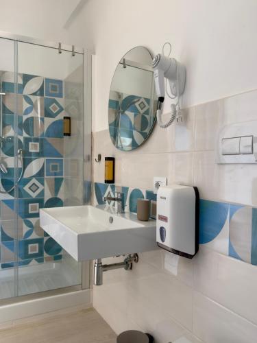 a bathroom with a sink and a mirror at Finestra sul mare Diamante in Diamante