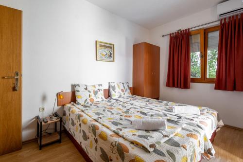 Postel nebo postele na pokoji v ubytování Bakal Apartments