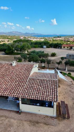 a house with a tile roof on top of it at Molti Mari B&B Resort in Olbia